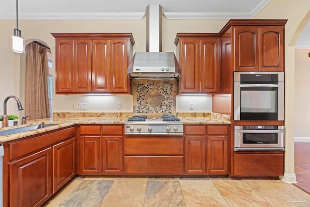 1011 Bucyrus Ln, Cantonment, FL 32533 - kitchen with wall chimney range hood, stainless steel appliances, a sink, light stone countertops, and ornamental molding