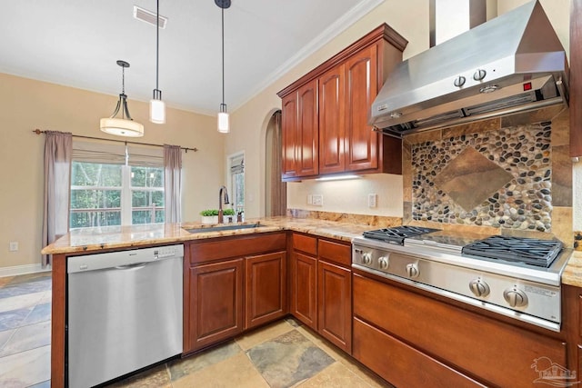1011 Bucyrus Ln, Cantonment, FL 32533 - kitchen featuring stainless steel appliances, wall chimney range hood, a sink, a peninsula, and tasteful backsplash
