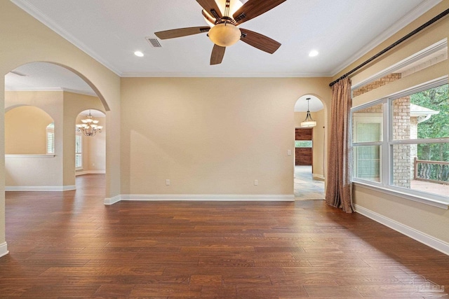 1011 Bucyrus Ln, Cantonment, FL 32533 - empty room with arched walkways, dark wood-style floors, ceiling fan, crown molding, and a chandelier