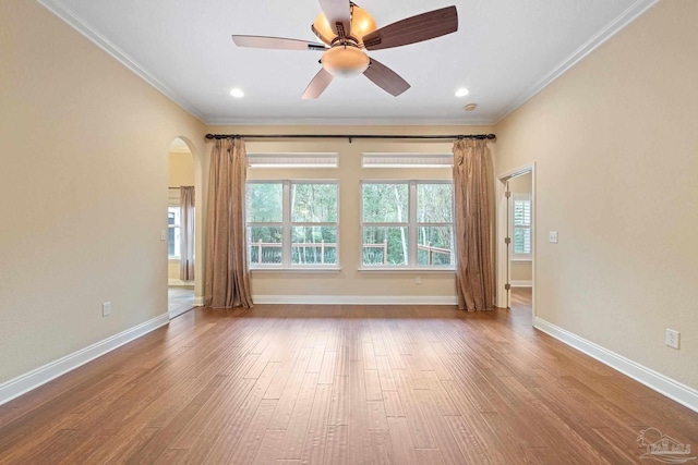 1011 Bucyrus Ln, Cantonment, FL 32533 - unfurnished room with ornamental molding, wood finished floors, arched walkways, a ceiling fan, and baseboards