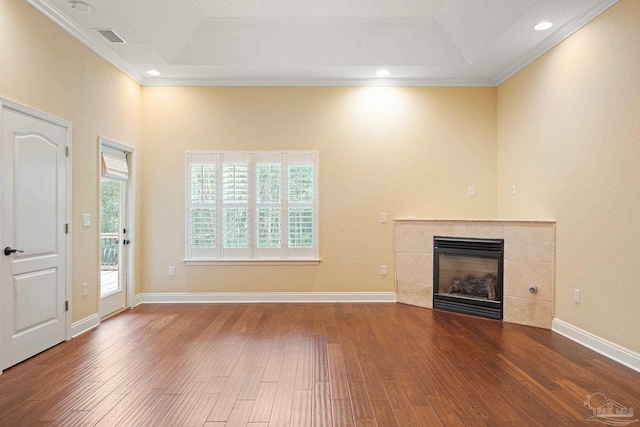 1011 Bucyrus Ln, Cantonment, FL 32533 - unfurnished living room featuring crown molding, wood-type flooring, a tile fireplace, a tray ceiling, and recessed lighting
