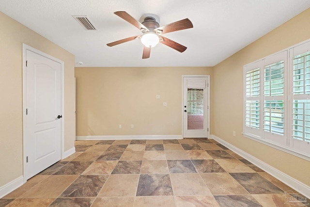 1011 Bucyrus Ln, Cantonment, FL 32533 - spare room with ceiling fan, stone finish flooring, and baseboards