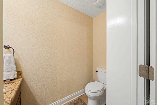 1011 Bucyrus Ln, Cantonment, FL 32533 - bathroom featuring vanity, toilet, and a textured wall