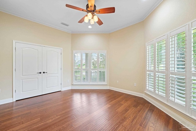 1011 Bucyrus Ln, Cantonment, FL 32533 - unfurnished bedroom with wood finished floors, crown molding, baseboards, a ceiling fan, and a closet