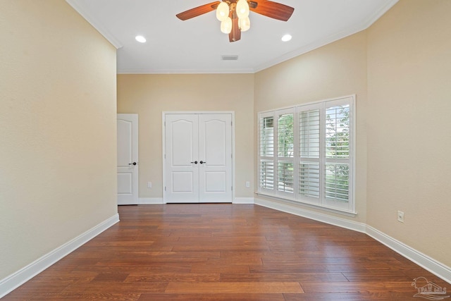 1011 Bucyrus Ln, Cantonment, FL 32533 - unfurnished bedroom featuring wood finished floors, crown molding, baseboards, ceiling fan, and a closet