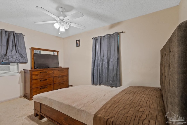 carpeted bedroom featuring a textured ceiling and ceiling fan