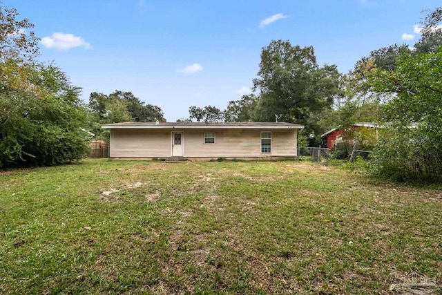 rear view of house with a lawn