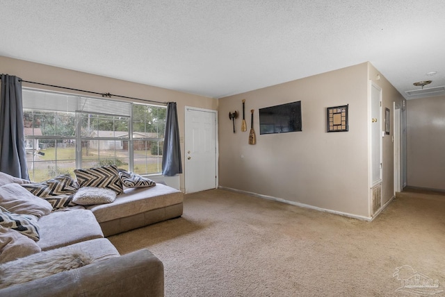 carpeted living room featuring a textured ceiling