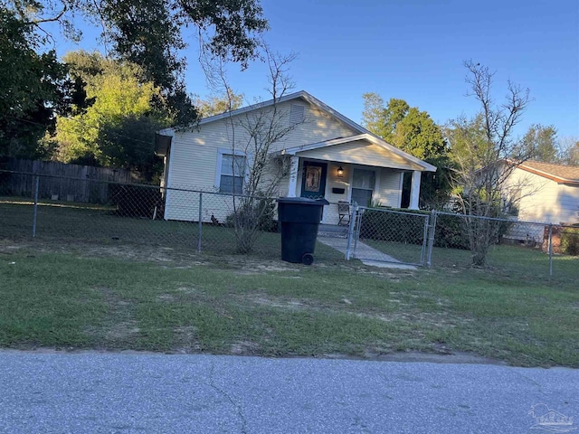 bungalow-style home featuring a fenced front yard, covered porch, a front lawn, and a gate