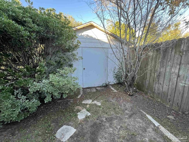 view of outbuilding featuring an outbuilding and fence