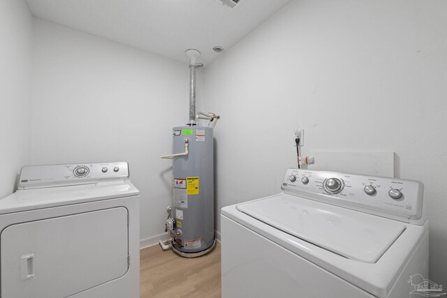 6216 Forest Pines Dr, Pensacola, FL 32526 - clothes washing area featuring independent washer and dryer, gas water heater, and light wood finished floors