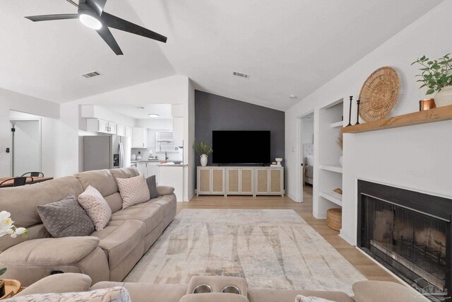 6216 Forest Pines Dr, Pensacola, FL 32526 - living area featuring lofted ceiling, ceiling fan, a fireplace, light wood-style floors, and built in features