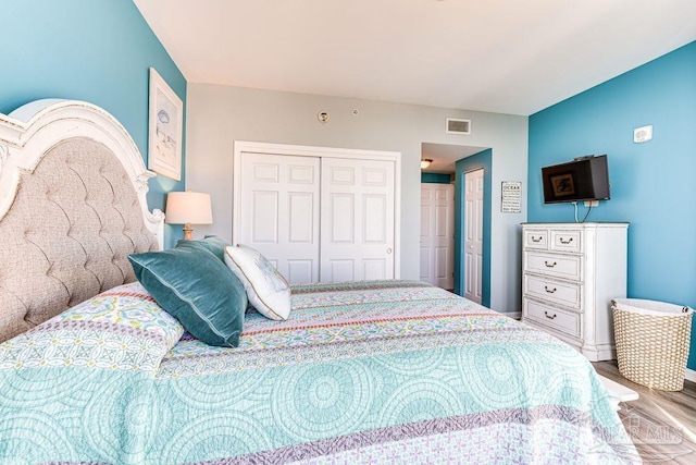 bedroom featuring hardwood / wood-style floors and a closet