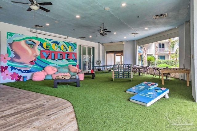 recreation room featuring ceiling fan and hardwood / wood-style flooring