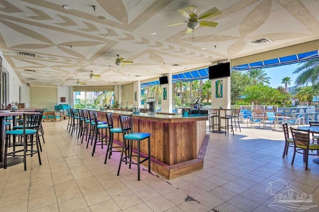 interior space featuring ceiling fan and light tile patterned floors