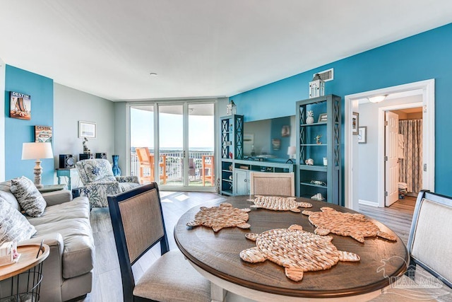 living room featuring light hardwood / wood-style floors and floor to ceiling windows