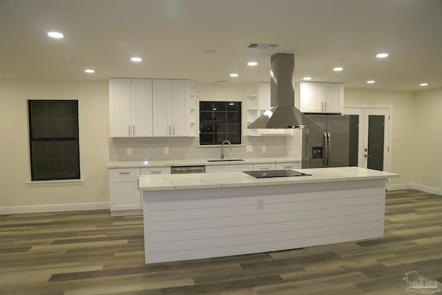 kitchen featuring dark wood finished floors, a sink, appliances with stainless steel finishes, white cabinetry, and island range hood