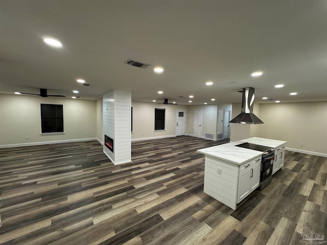 kitchen featuring electric range, ventilation hood, recessed lighting, and open floor plan