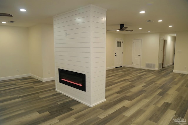 unfurnished living room with wood finished floors, recessed lighting, a fireplace, baseboards, and ceiling fan