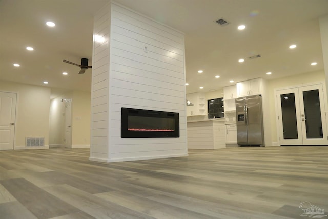 unfurnished living room featuring recessed lighting, visible vents, and french doors