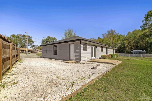 exterior space featuring a lawn and fence