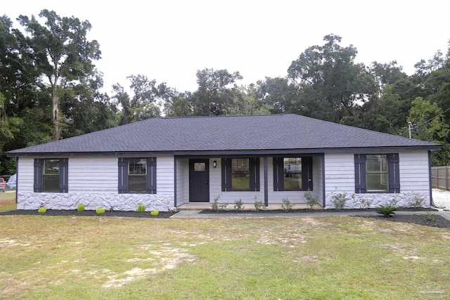 single story home featuring a front yard, stone siding, and roof with shingles