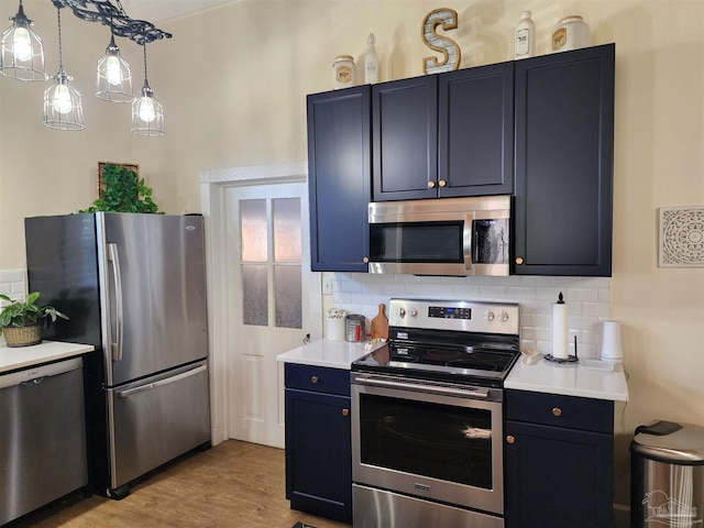 210 Mcrae St, Atmore, AL 36502 - kitchen with stainless steel appliances, decorative backsplash, light countertops, and light wood-type flooring
