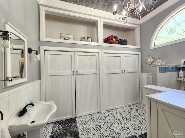 210 Mcrae St, Atmore, AL 36502 - bathroom featuring a wainscoted wall and a chandelier