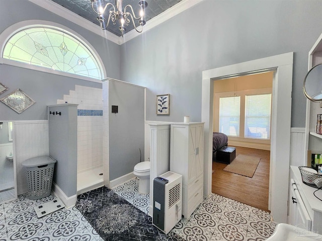 210 Mcrae St, Atmore, AL 36502 - full bath featuring a chandelier, crown molding, a walk in shower, a high ceiling, and wainscoting