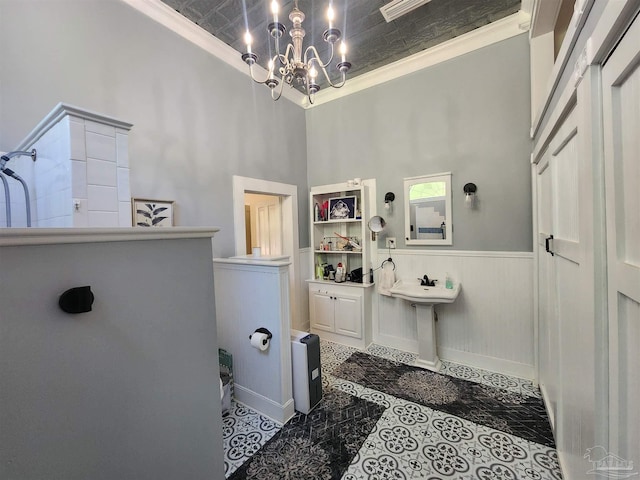 210 Mcrae St, Atmore, AL 36502 - full bath with ornamental molding, a chandelier, walk in shower, a wainscoted wall, and an ornate ceiling