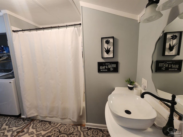 210 Mcrae St, Atmore, AL 36502 - bathroom featuring washer / dryer, shower / bath combo with shower curtain, ornamental molding, and vanity