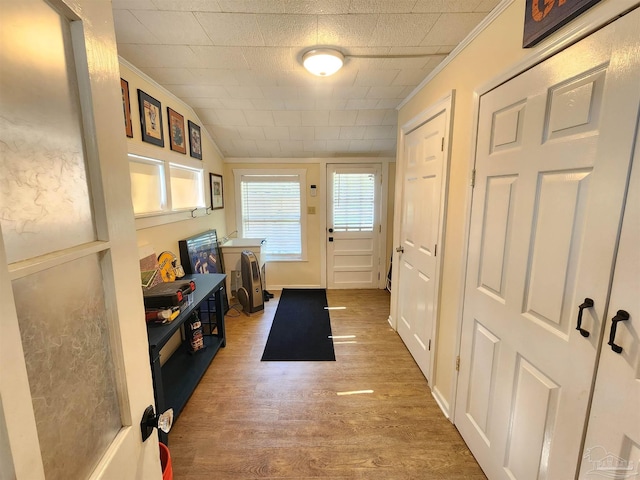 210 Mcrae St, Atmore, AL 36502 - doorway featuring wood finished floors, vaulted ceiling, and crown molding