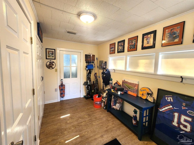 210 Mcrae St, Atmore, AL 36502 - game room featuring wood finished floors and crown molding