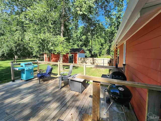 210 Mcrae St, Atmore, AL 36502 - wooden terrace with a grill, view of wooded area, and a fire pit