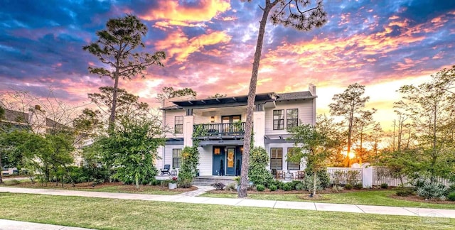 4979 Leeward Dr, Pensacola, FL 32507 - contemporary house with a lawn, a balcony, and fence