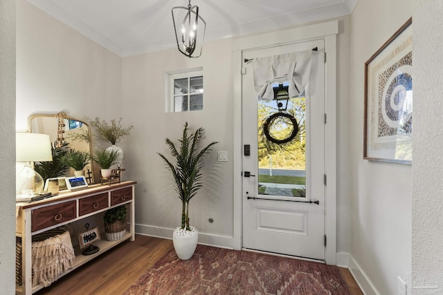 4979 Leeward Dr, Pensacola, FL 32507 - entryway featuring baseboards, a notable chandelier, and wood finished floors