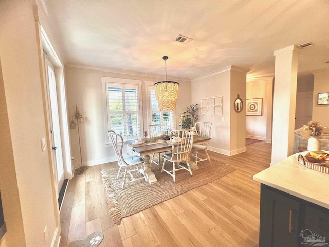 4979 Leeward Dr, Pensacola, FL 32507 - dining room featuring baseboards, crown molding, light wood finished floors, and an inviting chandelier