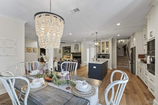 4979 Leeward Dr, Pensacola, FL 32507 - dining space featuring a chandelier, visible vents, light wood finished floors, and recessed lighting