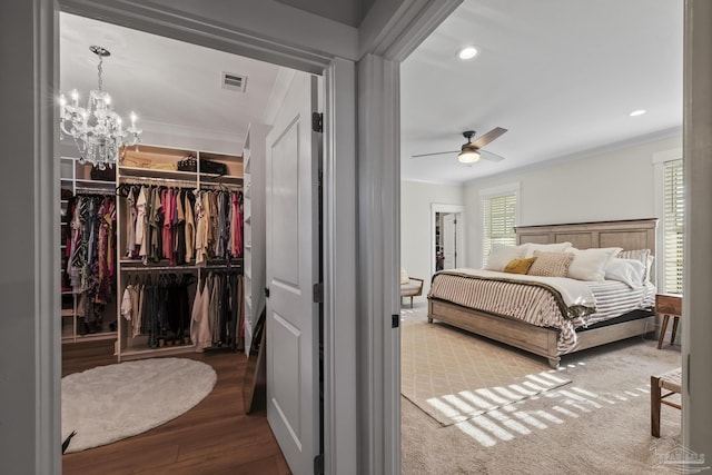 4979 Leeward Dr, Pensacola, FL 32507 - bedroom with wood finished floors, visible vents, a spacious closet, and crown molding