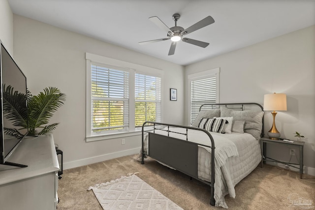 4979 Leeward Dr, Pensacola, FL 32507 - bedroom with baseboards, a ceiling fan, and light carpet