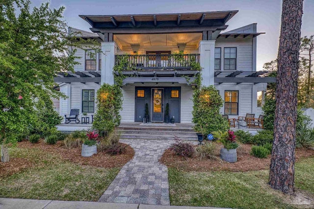4979 Leeward Dr, Pensacola, FL 32507 - view of front of house with a pergola, a porch, and a balcony
