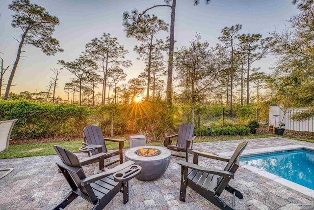 4979 Leeward Dr, Pensacola, FL 32507 - patio terrace at dusk with a fenced in pool and an outdoor fire pit