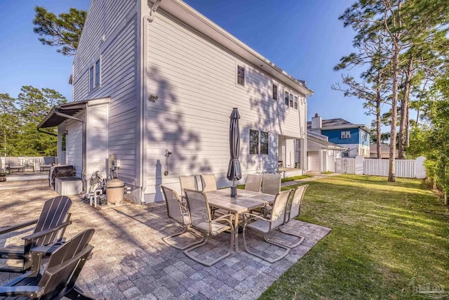 4979 Leeward Dr, Pensacola, FL 32507 - back of property with a yard, a patio area, outdoor dining space, and fence