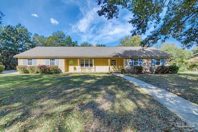 single story home featuring covered porch, board and batten siding, and a front yard