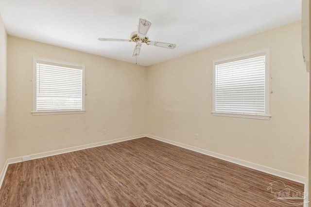 unfurnished room featuring wood finished floors, baseboards, and ceiling fan