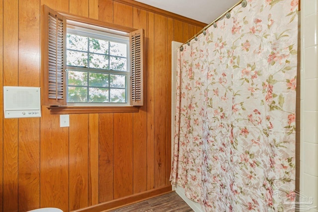 empty room with wood finished floors and wood walls