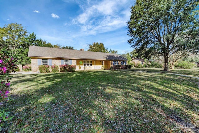 ranch-style house with a chimney and a front lawn