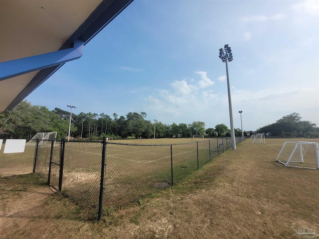 view of community featuring a sport area and fence