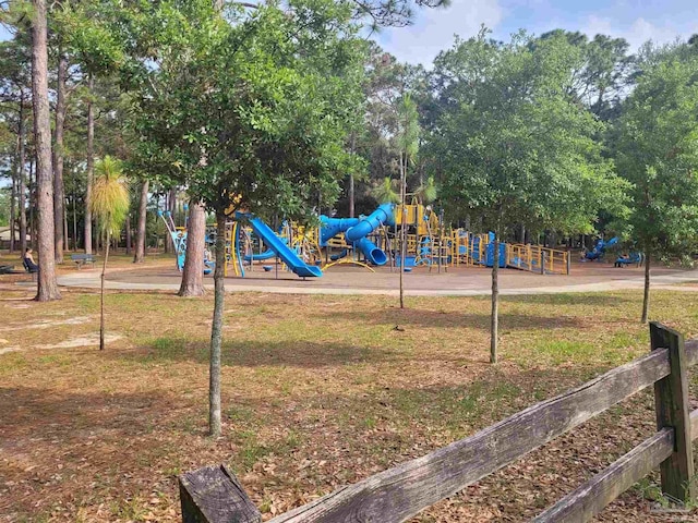 community jungle gym featuring a lawn and view of scattered trees