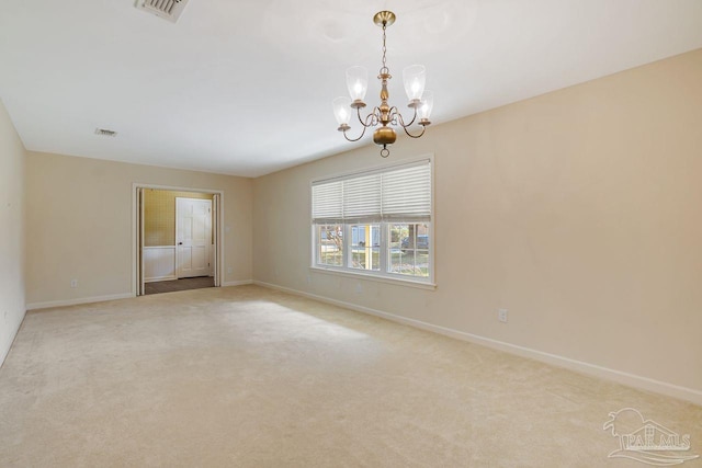 spare room with a chandelier, visible vents, light colored carpet, and baseboards